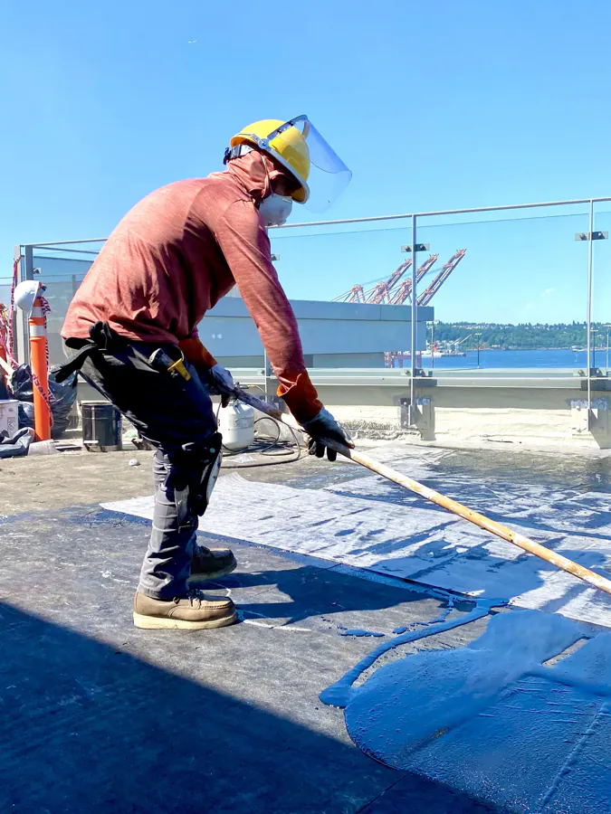 James King technician applying a waterproof coating to a deck
